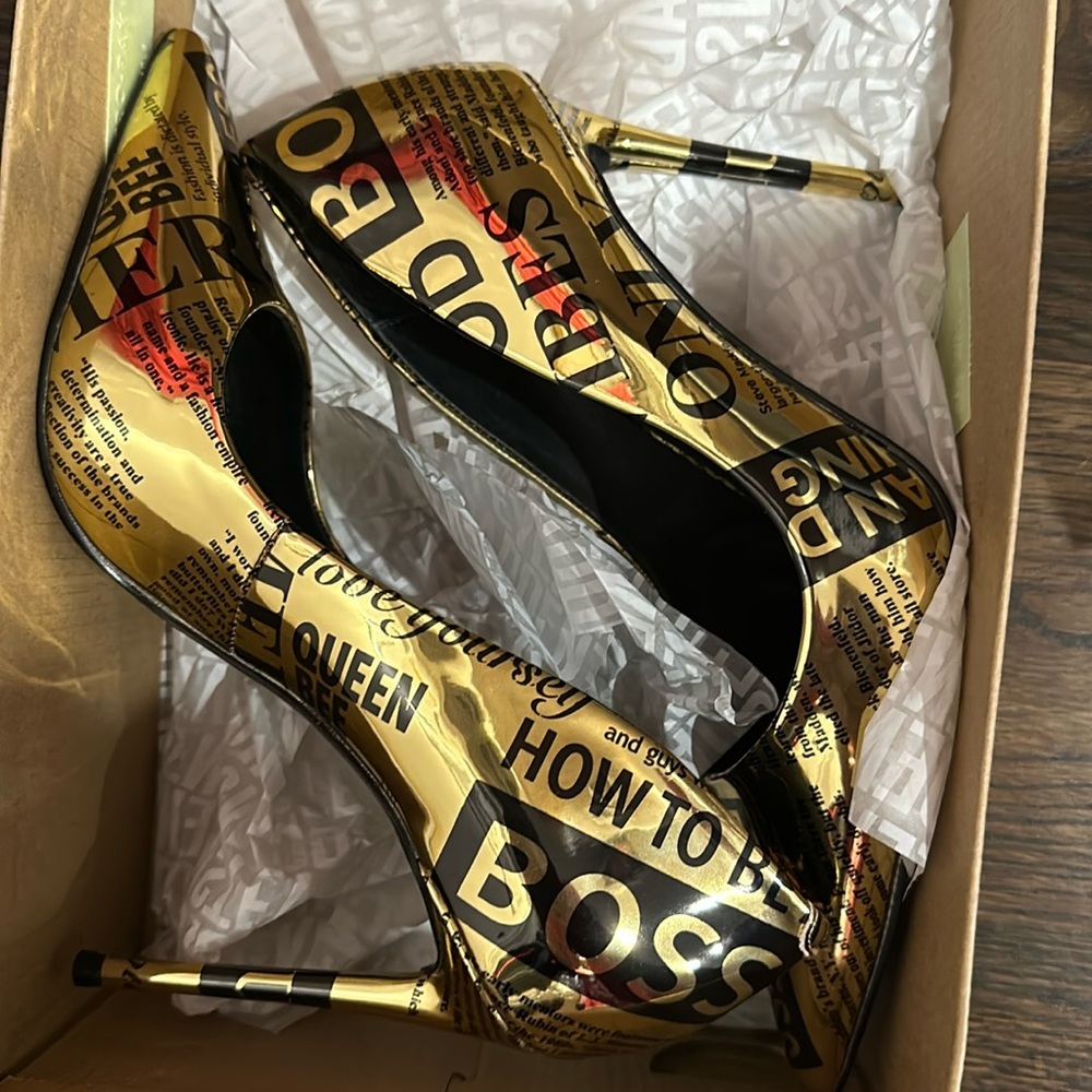Gold pumps with fabulous and boss fashion statement words written in black.